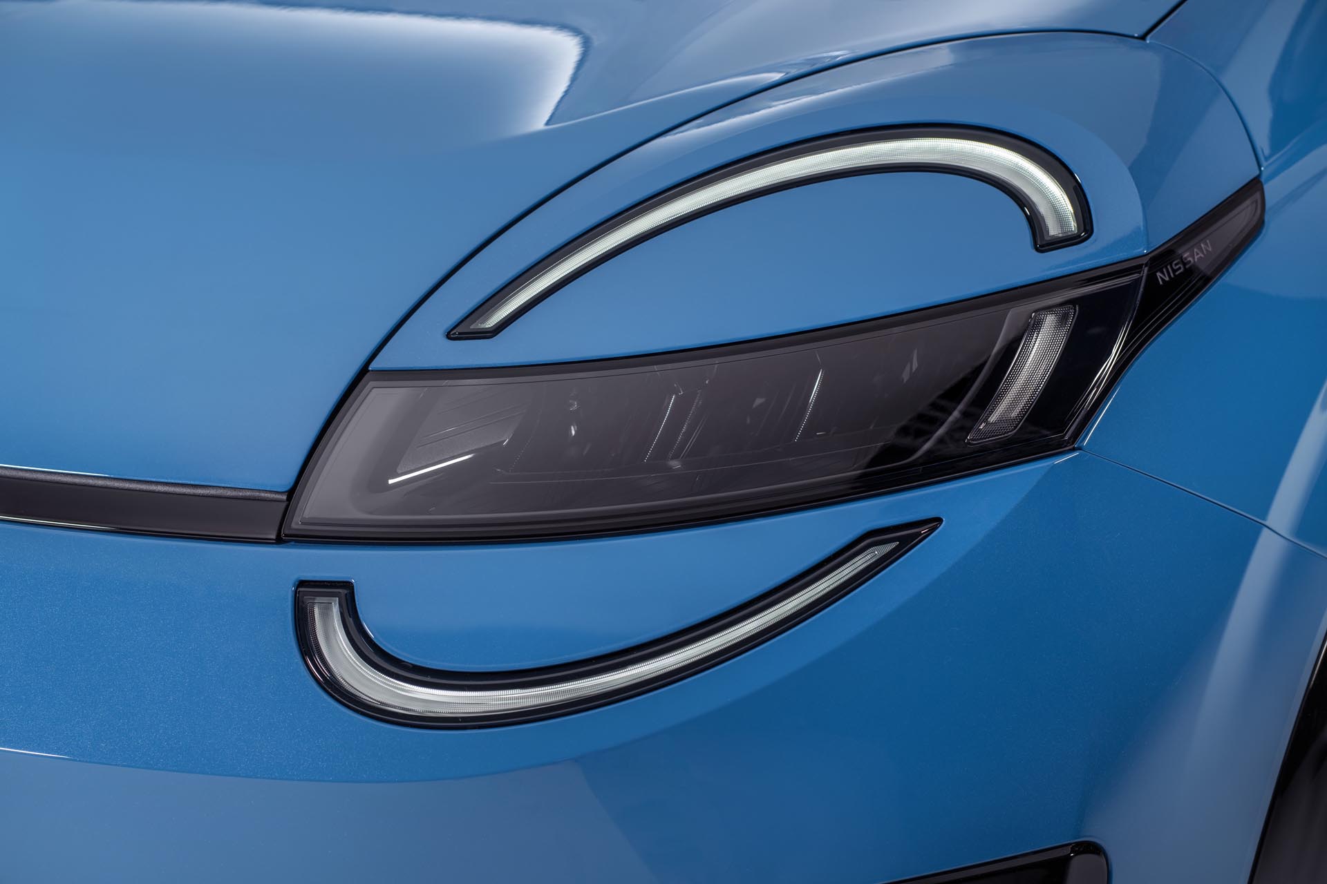 detailed shot of signature micra headlamps on blue body with led lights on