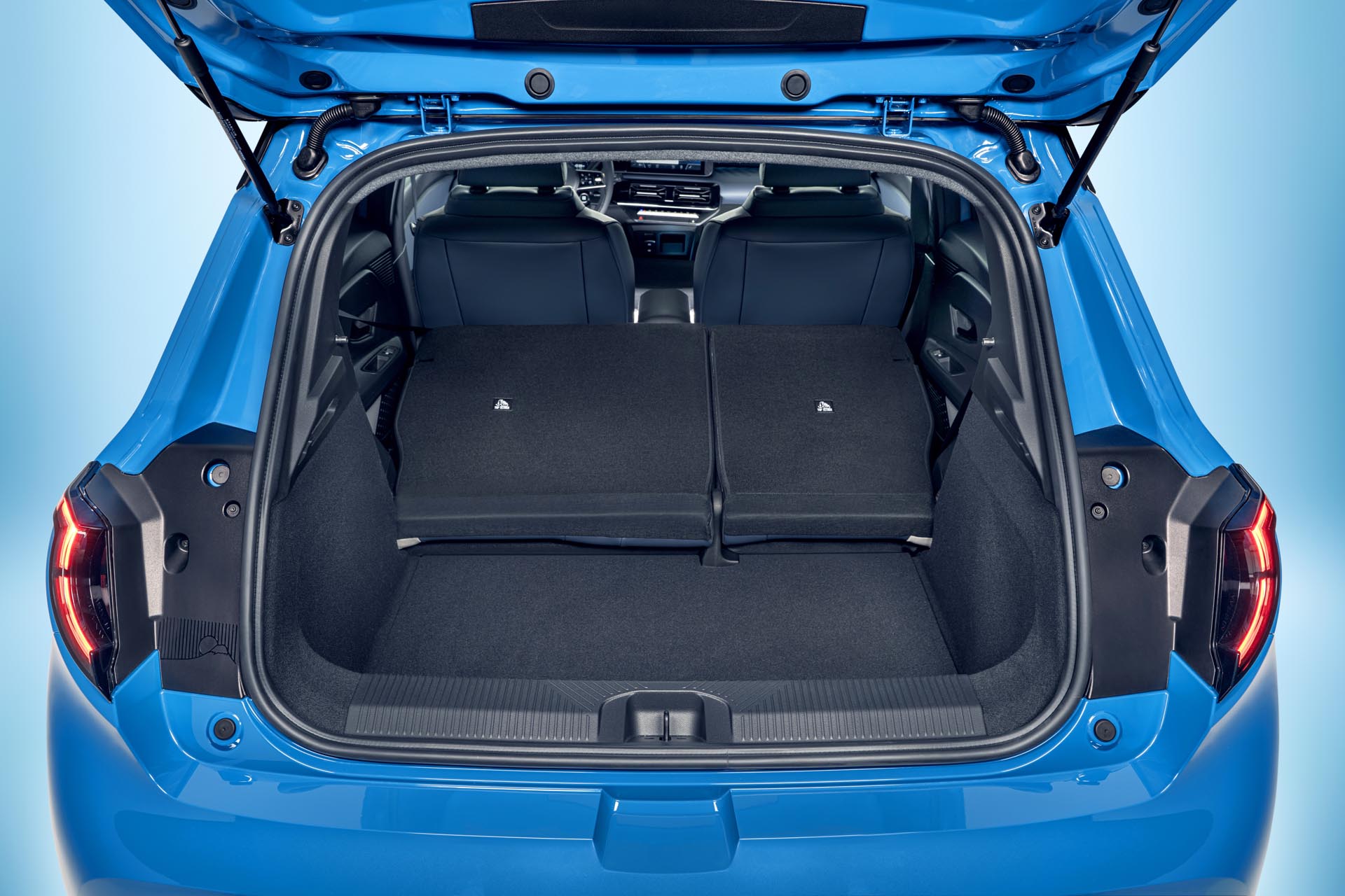focused view of Micra trunk space with open trunk door and collapsed seats